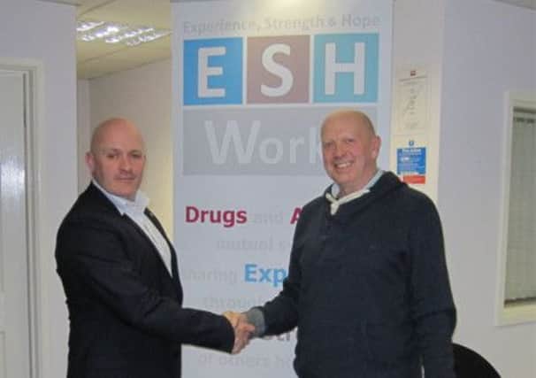 Will Johnston, commissioning manager for substance misuse in Warwickshire, confirms the grant to ESH Works chief executive Paul Urmston.