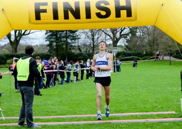 Andy Savery crosses the line at the Regency 10k Run