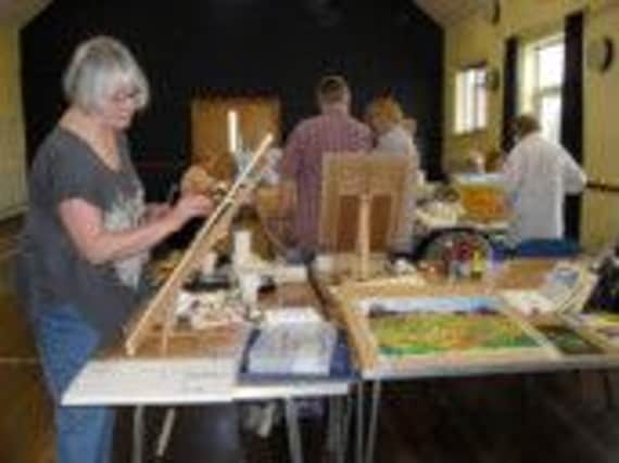 Members of Napton Art Group prepare for their exhibition.