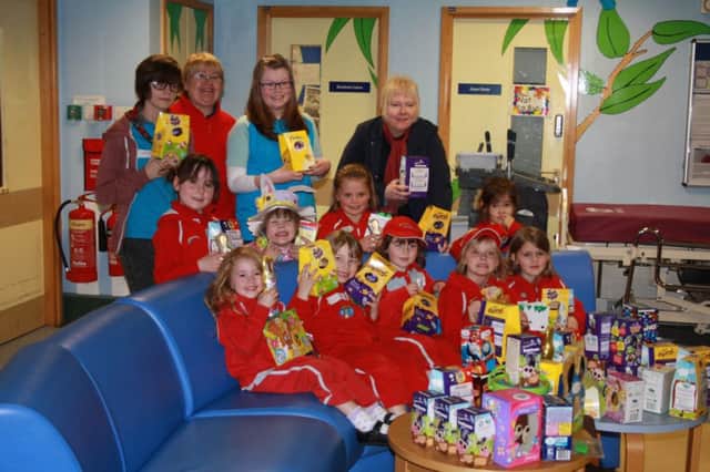 Vic Minette joins girls and guiders from the 10th Leamington St Marks Rainbows unit with their Easter eggs donations at the McGregor childrens ward at Warwick Hospital.