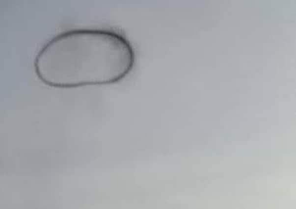 Did you see this mysterious black ring in the sky above Warwick on Saturday? Credit: Nikki Child