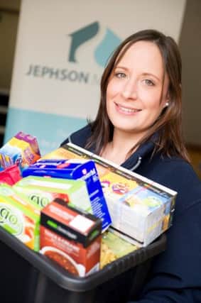 Keira Lymath, Jephson Housing Associations financial inclusion officer for the Midlands region, with a box of donations.
