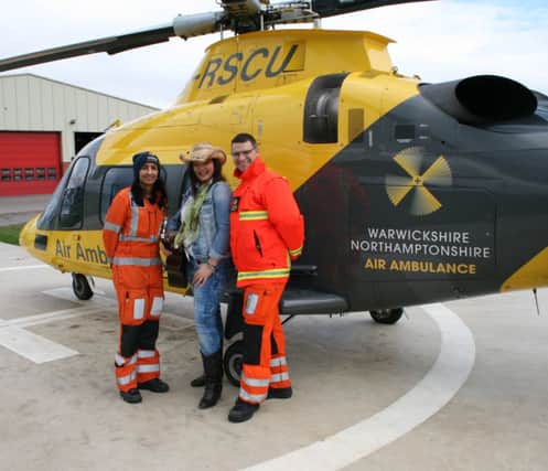 Lya of Not Taken launches the Kineton Music Festival at the Warwickshire and Northamptonshire Air Ambulance base with Dr Nagreena Hussain and paramedic Paul Mullins.