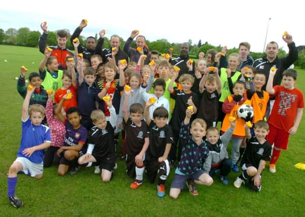Coaches and players at Lillington Juniors show off their Sainsburys-supplied oranges. Picture submitted