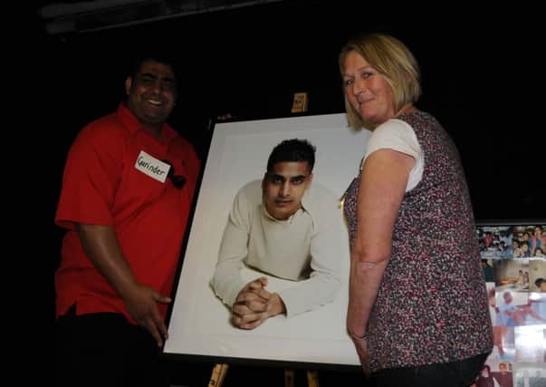 The Sunny Dhillon Memorial Day Sunny's brother Gurinder Ghag and Carol Formosa display his picture. NNL-140518-163929009