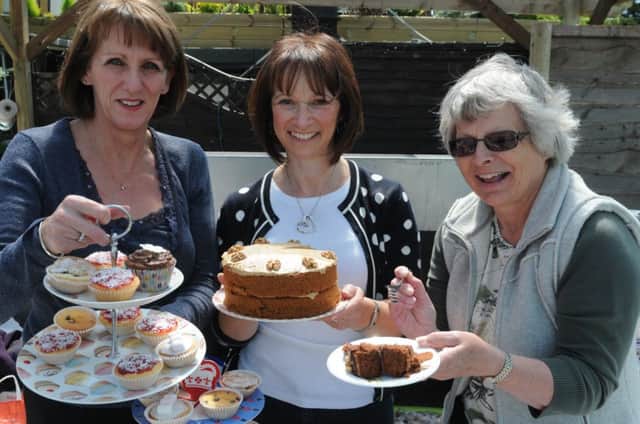 Gillian Parkin,Sarah Stachan and Elaine Brain show off the cakes on offer at their homemade cakes stall at last year's Ufton fete.
