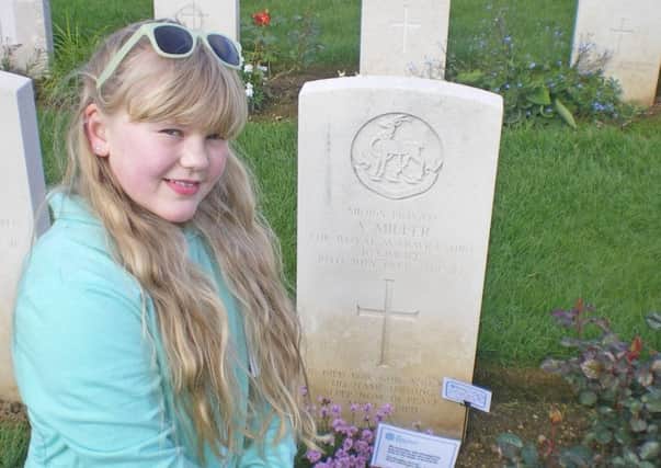 Izzy Miller at her great grandfather Arthur's grave at the Ranville War Cemetery in Normandy.