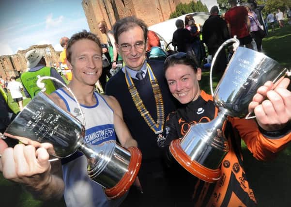 Andrew Savery and Danielle Stewart show off their trophies for first male and female alongside Kenilworth Rotary Club president Richard Martin. Picture: Mike Baker