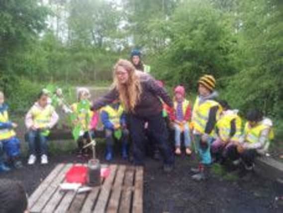 Education advisor Rachel Adshead leads a group visit of children to Foundry Wood in Leamington.