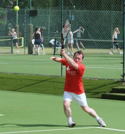Chris White MP doing his bit at Warwick Boat Club's 24-hour charity tennis-a-thon.