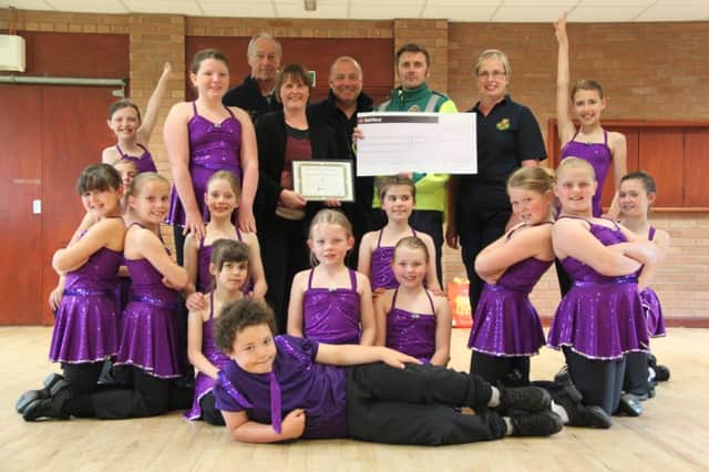 Pupils from the Sarah Cooke School of Dance hand over their donation to the Bubbenhall First Responders.