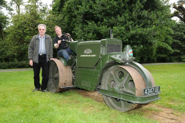 Anthony Coulls in Victoria Park at the wheel of the road roller he restored with his father Peter.