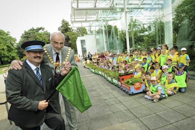 The annual geranium train launch took place on Tuesday, at Jephson Gardens, for the Leamington in Bloom for schools.  Pictured: Nick Rees (Station Host), John Knight (Mayor of Leamington) & Karen Bowden (Station Manager), joined the school children to get the launch underway. NNL-140107-212600009
