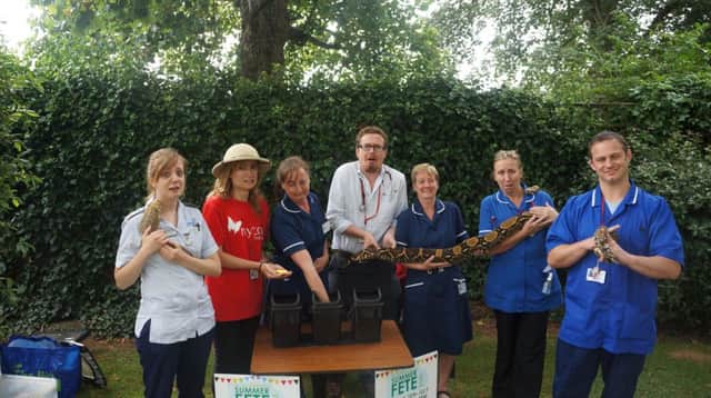 Doctors and nurses from Mytontake on the 'bush tucker trial' challenge with events co-ordinator Lucy Turner (red Myton t shirt) and Kate from KPN reptiles (far right).