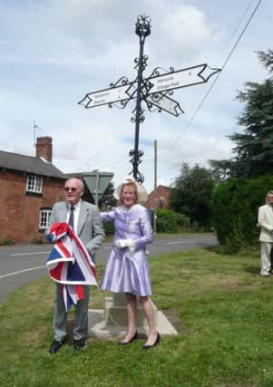 High Sheriff of Warwickshire Claire Hopkinson unveils the sign in Norton Lindsey with parish council chairman Nick Burns.