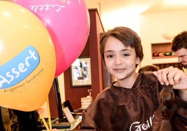 Leila Ally, nine, after her hair cut in aid of Assert and the Little Princess Trust. NNL-140715-194938009