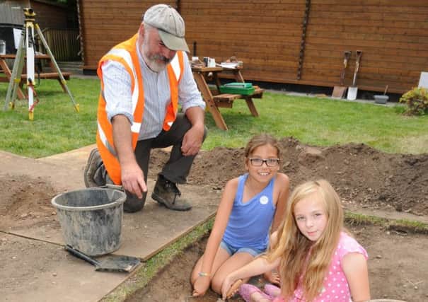St John's House Museum in Warwick invited adults and children to volunteer to help with an archaeological dig on Saturday. Pete Thompson from Archaeological Warwickshire is pictured in the garden with youngsters Daisy Jennings 9 and Pele Lovell 8.

MHLC-26-07-14 Archeological dig Jul NNL-140728-104127009