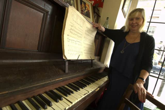 Maggie Garton, Warwick Antiques Centre, pictured with the original piano which A Long Way to Tipperary was first played, as the troops went out to war.