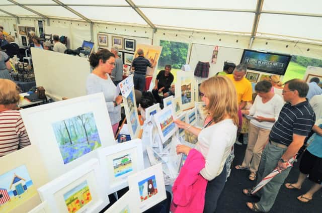 Crowds look at the art on display in the Art in the Park festival in Leamington.