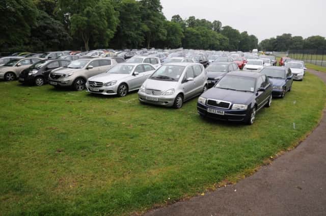 Cars parked on Victoria Park for the Bowls England Women's National Championships.