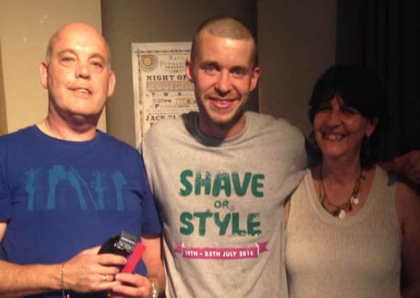 Steve Rowbotham (centre) after the head shave with his mother Lesley Chapman (right), Paul of the Smith Street barbers in Warwick (left) .