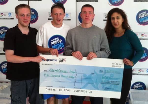 Chapter 1 clients Jack, Lee and Alex with Warwickshire sports co-ordinator Farah Naz, picking up their £500 cheque from StreetGames.