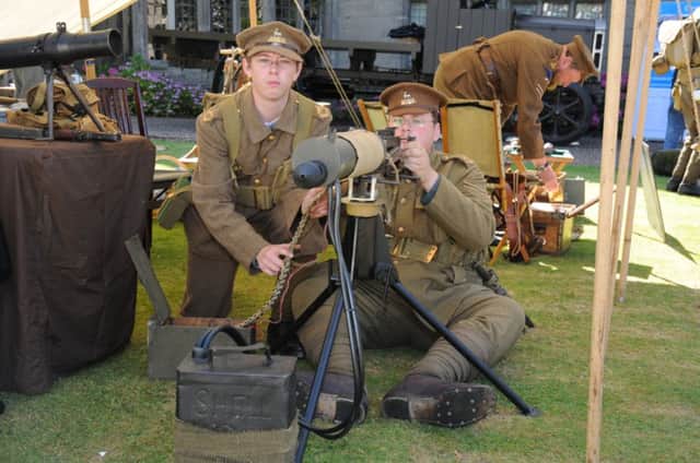 Graham Cadman and Richard Cartwright from The Birmingham Pals war re-enactors group, with a Vickers machine gun, at the launch of Warwickshire at War at St John's Museum in Warwick.
