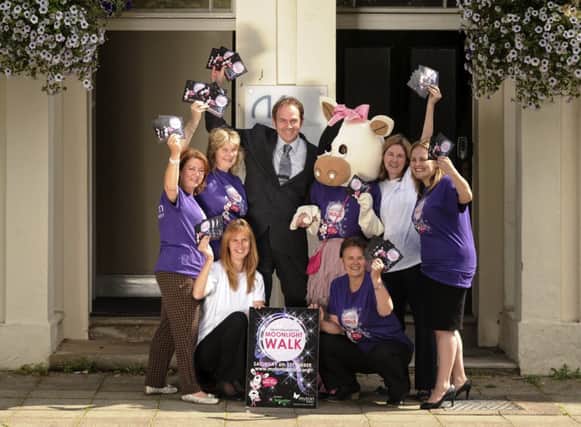 Staff at Alsters Kelly solicitors in Leamington with Sara Revell from Myton Hospice and the new Moonlight Walk mascot Patsy.