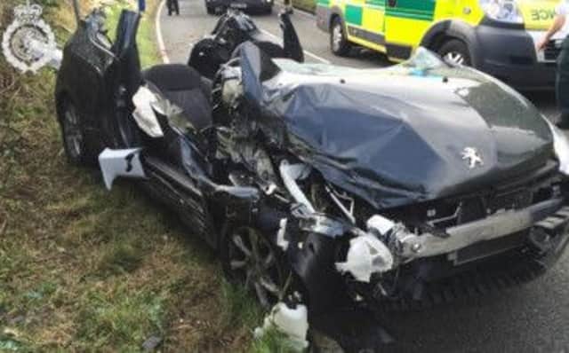The driver of this Peugeot was unhurt after being involved in a crash with another car and trailer and a van and trailer near Warwick. Picture courtesy of West Midlands Ambulance Service.