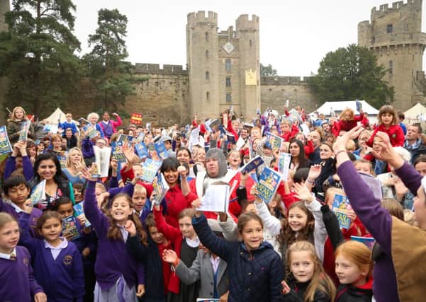 Children celebrate their new Guinness Book of Records after listening to The Measly Middle Ages in the Horrible Histories series.