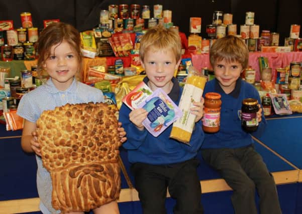Samantha, Alex and Arthur, all pupils at St Mary Immaculate Primary School in Warwick, who helped at the harvest festival.