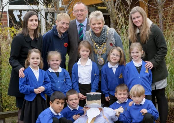 Pupils from Newburgh Primary School and their 'guy', pictured together with Claire McGurk (Taylor Wimpey), Jackie Crampton (Warwick Town Bonfire), Andrew Smith (Head Teacher), Moira-Ann Grainger (Mayor of Warwick) & Rachel Appleby (Taylor Wimpey). NNL-140411-233755009