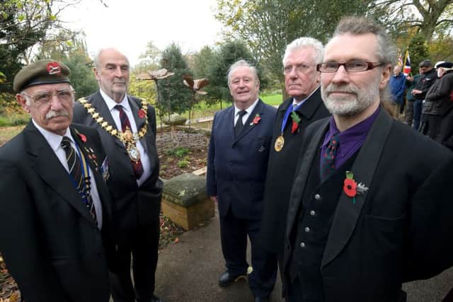 To mark the centenary of the outbreak of World War One, a commemorative sculpture 'Barbed Poppies', was unveiled and dedicated in Jephson Gardens, Leamington, on Tuesday. Pictured with artist Tim Tolkien (front right) are (from l-r) Vince Watson of the Leamington branch of the Royal British Legion, Leamington Mayor Cllr John Kinght and Warwick district councillors Dave Shilton and Alan Wilkinson.