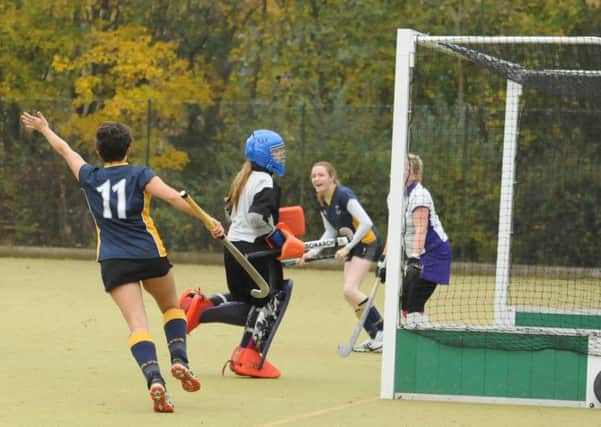 Vicky Allison (far side) opens the scoring for Warwick 3rds against Sutton Coldfield 5ths. Picture: Morris Troughton