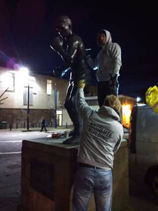 The Randolph Turpin statue in Market Square, Warwick, being cleaned and polished.