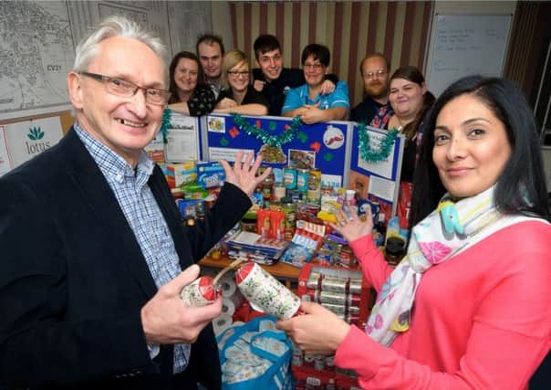 Staff at Lotus Care in Leamington Spa, have been collecting items for the food bank for Christmas. The were recently visited by Andy Bower (Operations Manager - Warwick & Leamington Food Bank).  Pictured: Andy Bower (Operations Manager - Warwick & Leamington Food Bank), Jaz Nijjar and Staff (Lotus Care). NNL-141125-232854009