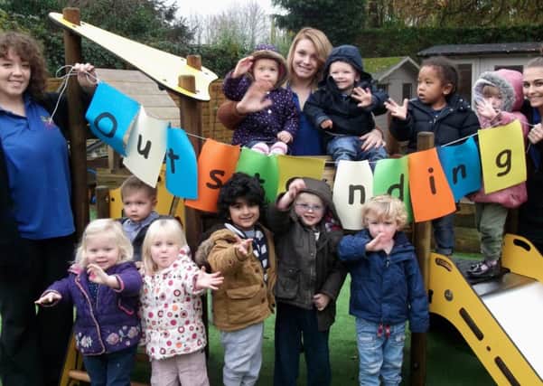 Budbrooke Nursery children celebrate their outstanding Ofsted report with Early Years Practioners l to r: Nikita James, Lyndsey Tench and Emily-Rose Tomlin.