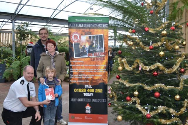 Watch commander Scott Moultrie gives fire safety advice to Lloyd, Abbie and their son Alfie at Smith's Nurseries and Garden Centre.
