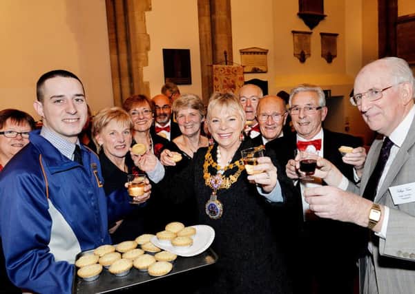 Will Mander, (left)Deputy Store Manager of Aldi , Leamington Spa helps to hand out mince pies and wine they have donated to The Village Voice Choir, Warwick during a concert at St Nicholas Church, Warwick. Attended by the Mayor of Warwick Cllr Moira-Ann Grainger. (rt is the Village Voice Choir President Peter Grimbly)
