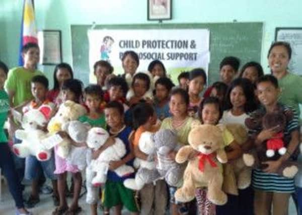 Children in the Philippines with some of the cuddly toys