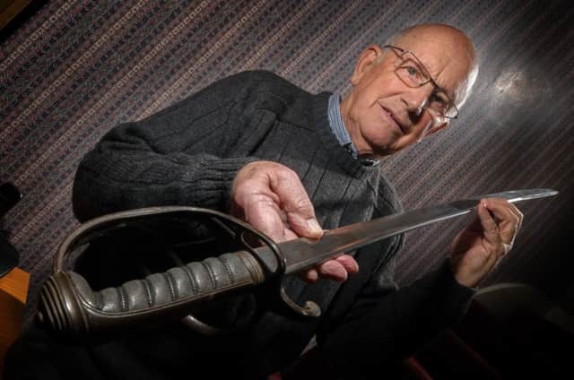 Derek Billings, pictured with his ancestor's sword, who was at the Battle of Waterloo. NNL-150128-012643009
