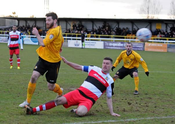 Leamington goalscorer Danny Newton gets in ahead of former team-mate Liam Daly to get in an effort on goal.  Pictures: Morris Troughton