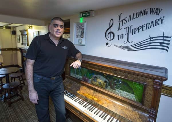 The Tipperary Inn in Honiley, Warwickshire.  Landlord Mike Malham with some of the memorabilia in the pub where the famous song "It's a long way to Tipperary" was written.