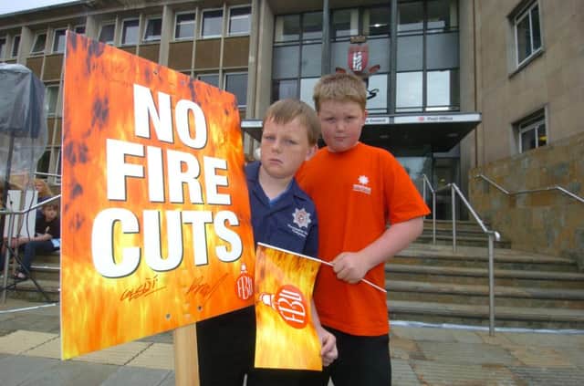 Fire protests outside Shire Hall inn 2010 as councillors gathered to vote on proposals to close Warwick fire station.  Warwickshire Young Firefighters Harry Sandell and Alex Kempton, both from Warwick.