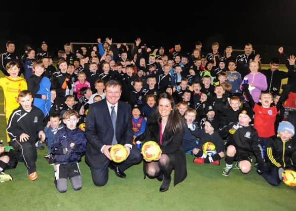 Robert Lee and Sophie Millard of Leamington law firm Wright Hassall, which gave legal and practical support in the bid for charitable status,  with young players from Lillington Juniors Football Club. For more information about the club visit www.lillingtonjuniorsfc.co.uk or call 07867 484013.