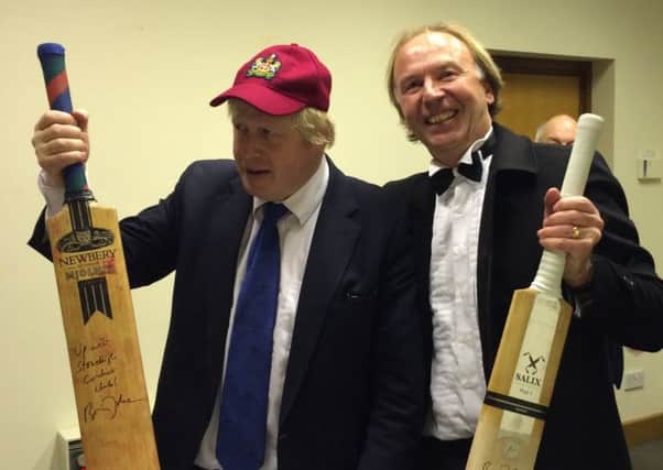 Boris Johnson and Paul Smith of Stoneleigh Cricket Club with the signed bats.
