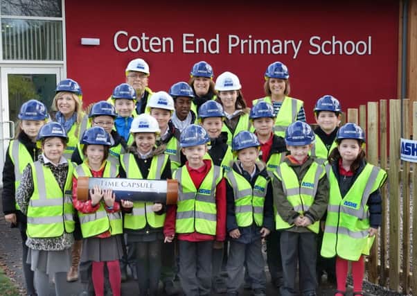 Children from Coten End Primary with their time capsule.