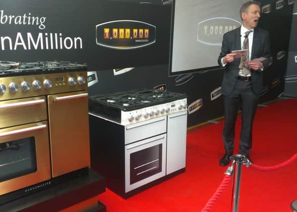 William McGrath, chief executiv eof the AGA Rangemaster Group, delivers his speech during the unveiling of the company's one millionth range cooker. On the far left is the golden Nexus 90  and closest to Mr McGrath is a special commemorative cake made for the occasion.