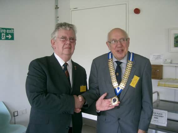 George Quantrill (left) hands over his chain of office to Richard Ratcliffe who now becomes head of Warwick Number 2 Probus Club.