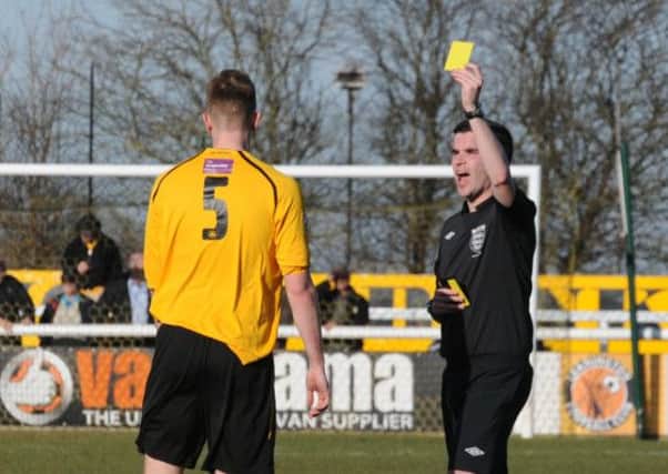 Referee Chris ODonnell hands out a yellow card to Jamie Tank against AFC Fylde last Saturday. Picture: Morris Troughton